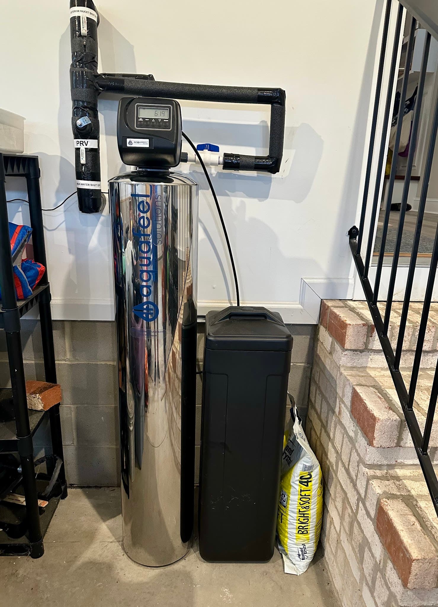 Aquafeel whole house water system professionally installed in a home garage