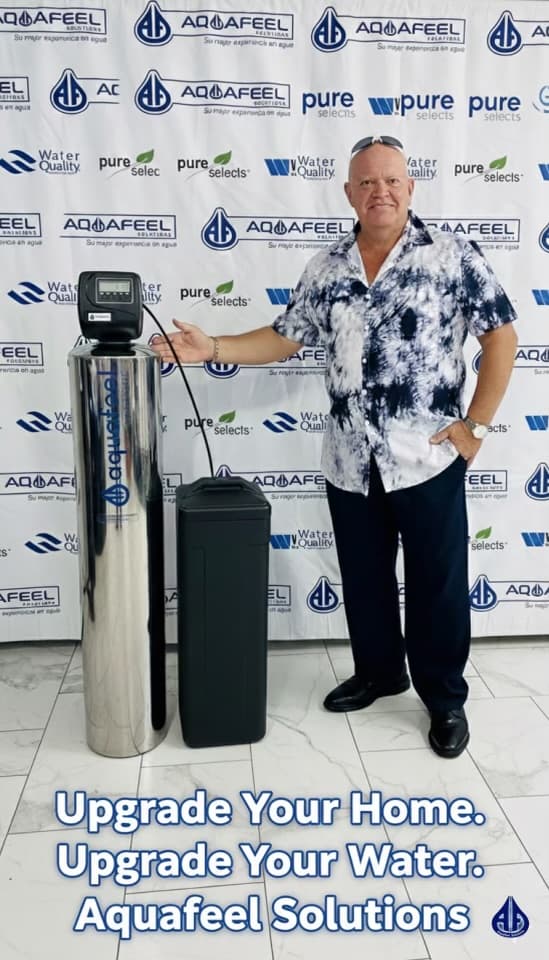 Aquafeel Solutions team member showcasing a whole-house water filtration system